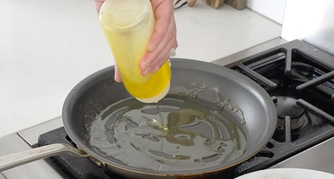 adding oil to a pan