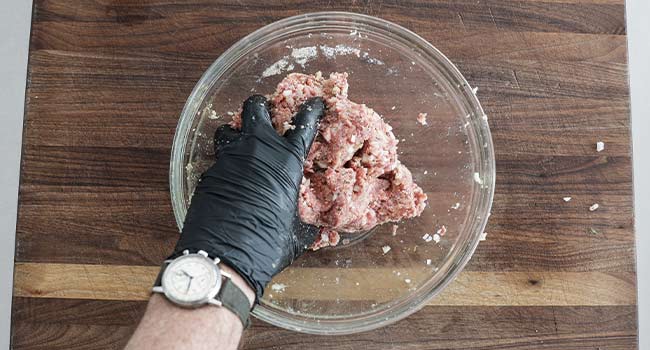 mixing baked meatball ingredients