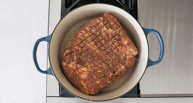 searing a pork butt in a pot