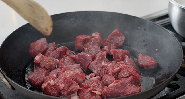 beef searing in a pan