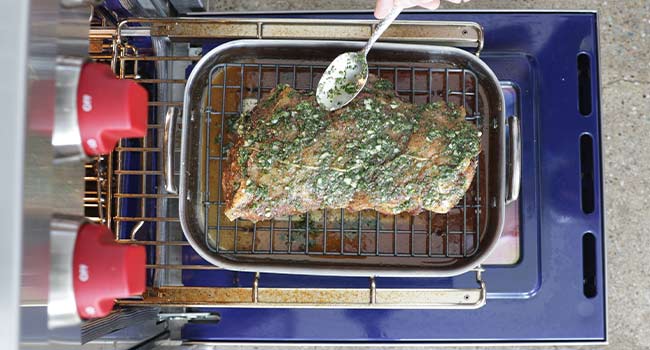 adding herbs to a pork roast