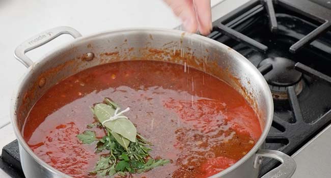 tomato sauce with herbs in a pot