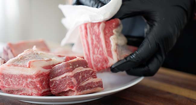 patting dry short ribs