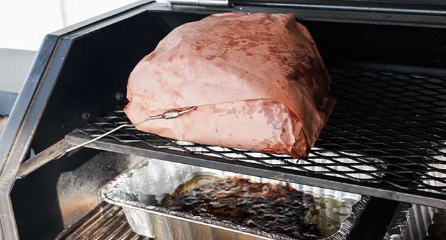 wrapped pork butt on a smoker