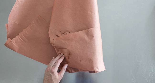 folding butcher paper over a pork butt