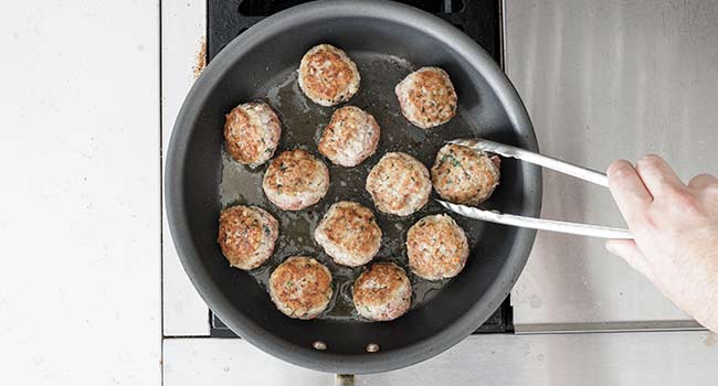 meatballs frying in a pan