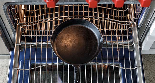 adding a cast iron pan to an oven