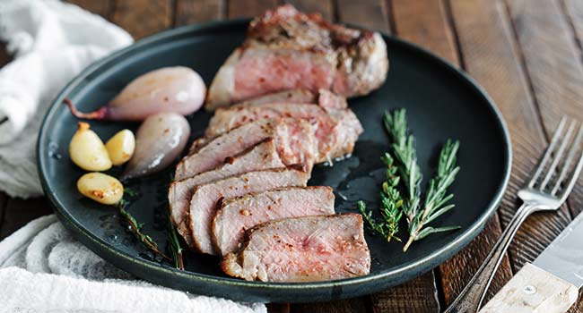 sliced steak with roasted garlic and shallots