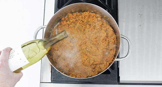 deglazing a pan of veggies with white wine