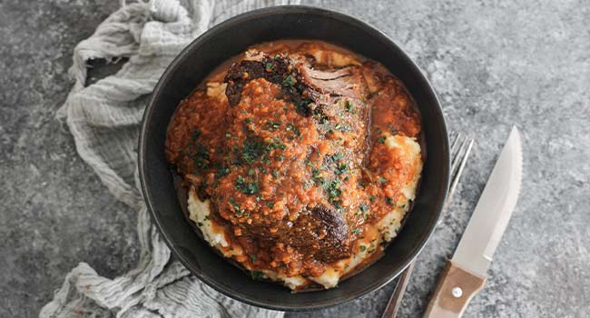 chuck roast with mirepoix gravy and mashed potatoes