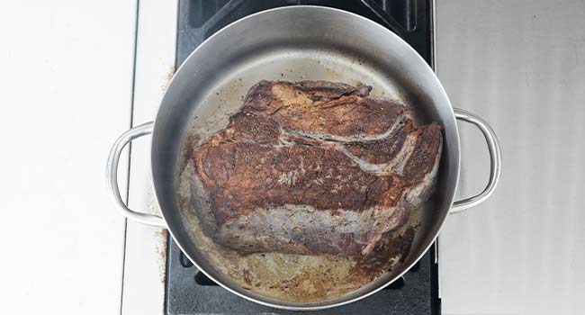 browned chuck roast in a pot