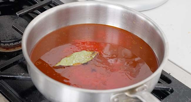 tomato sauce with a bay leaf in a pot