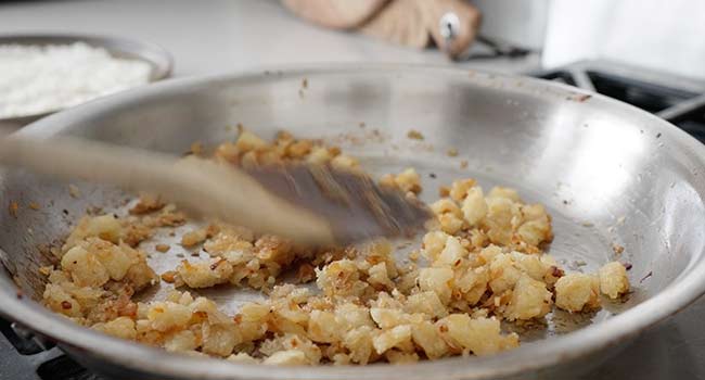 folding bread into cooked onions