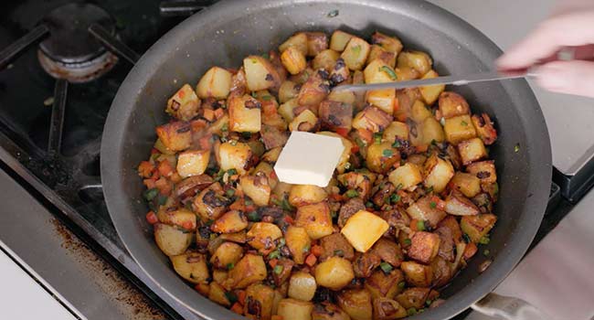 adding butter to home fries