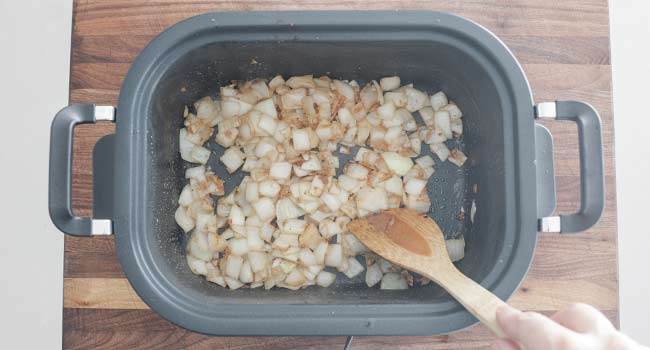 stirring browned onions in a crockpot 