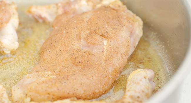 adding chicken to a pan