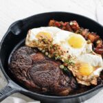 steak and eggs in a skillet