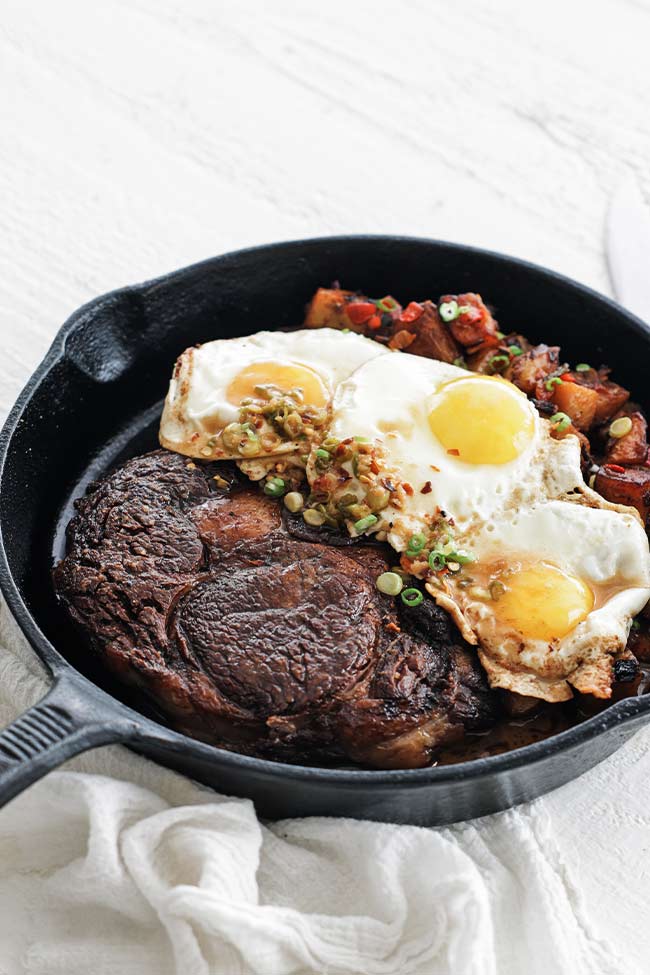 steak and eggs in a skillet