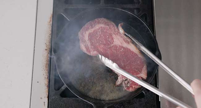 moving a steak around in a pan