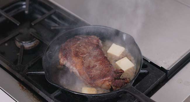 butter in a pan with steak