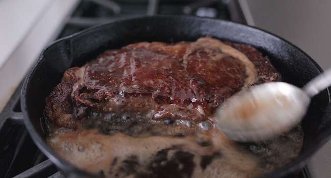 basting a steak