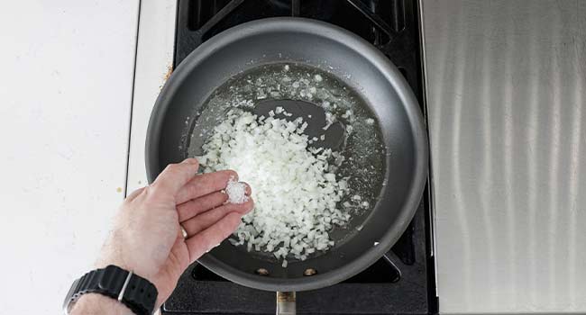 sautéing onions in a pan