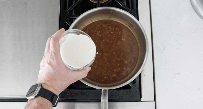 adding cream to a beef gravy