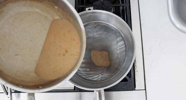 straining a creamy beef gravy