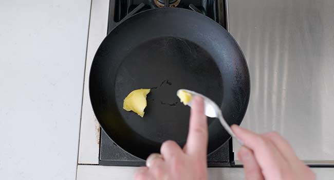 adding ghee to a pan