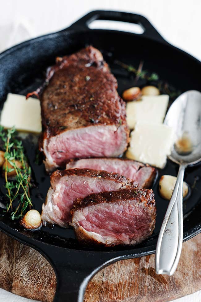 sliced steak in a pan with butter