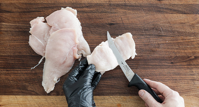 slicing chicken breasts in half