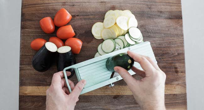 slicing veggies on a mandolin