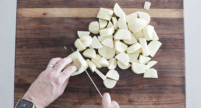 cutting peeled potatoes