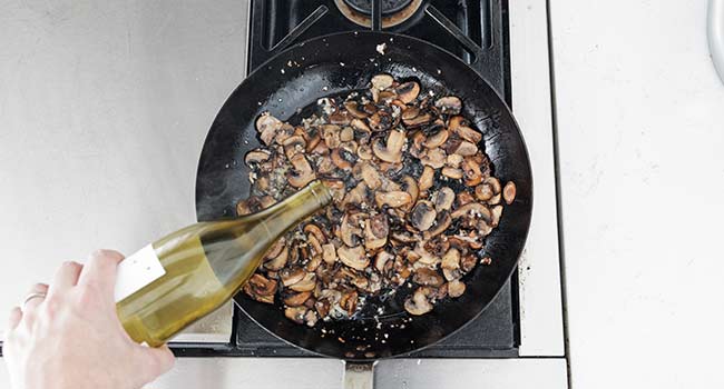 adding wine to sauteed mushrooms