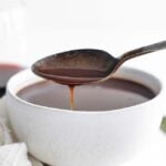 pouring bordelaise sauce into a bowl