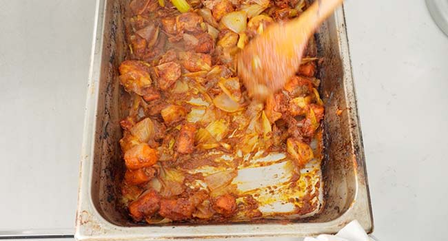 mixing tomato paste with roasted veggies