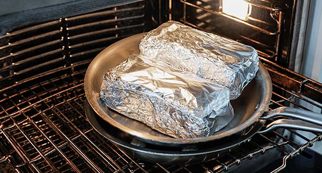 adding a brick chicken to the oven