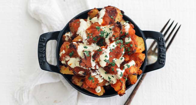 patatas bravas garnished with parsley