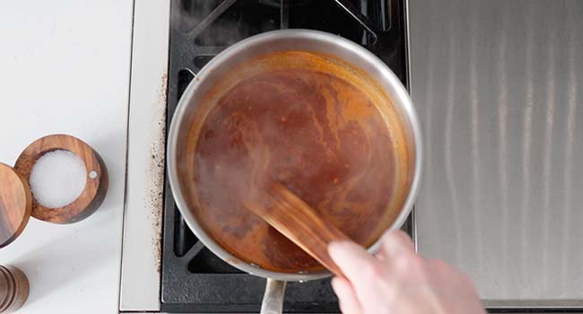 salsa bravas cooking in a pan