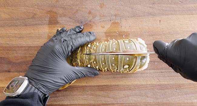 cutting through a lobster tail