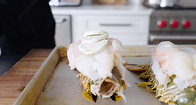 adding butter to lobster tails