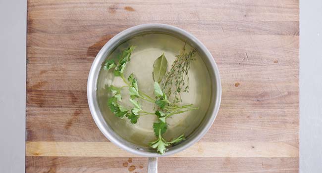 herbs and wine in a pot