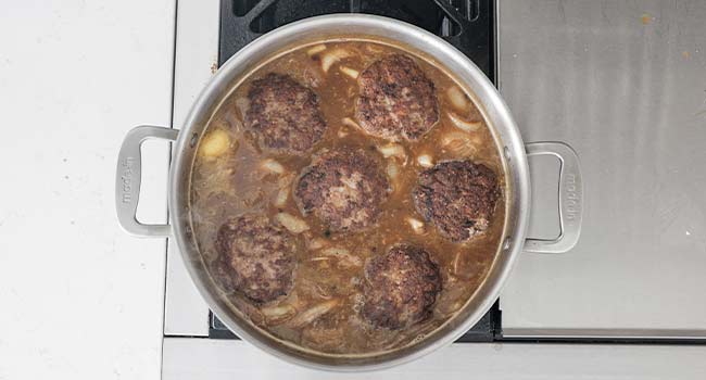 simmering hamburger steaks in onion gravy