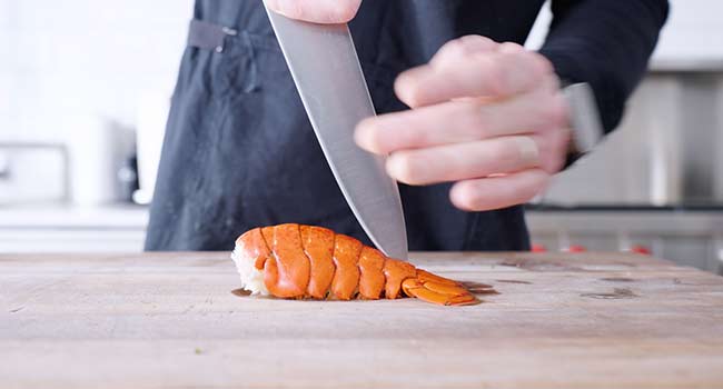 slicing a lobster tail in half