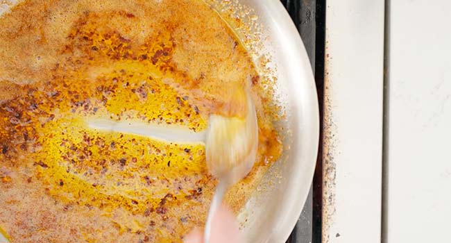 mixing pepper and aleppo pepper in a pan